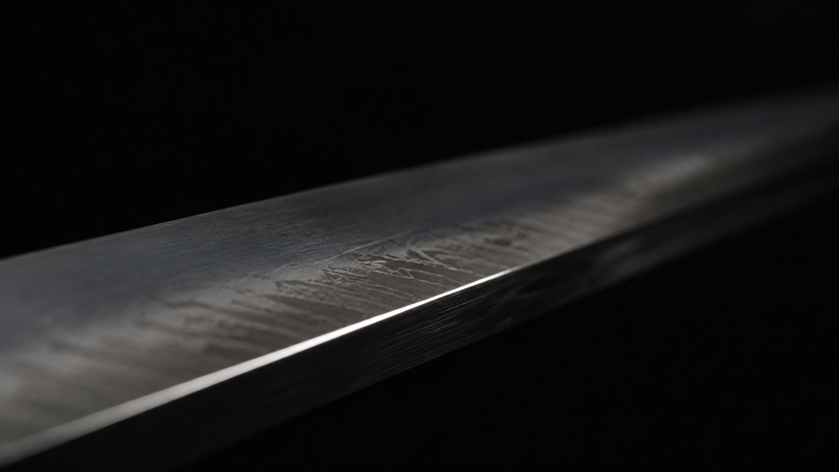 close detail of blade on cutting board, dark